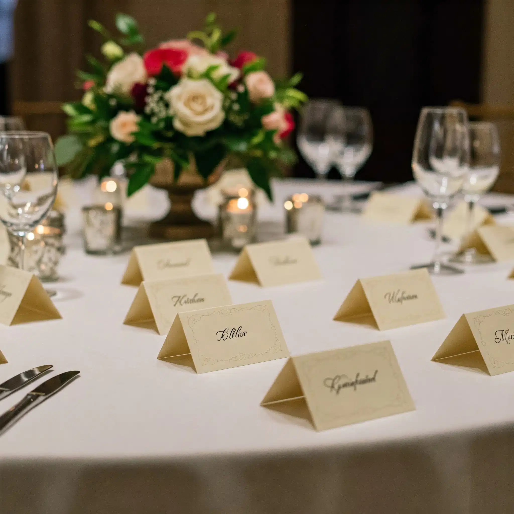 White scored card place cards folded and standing on a table